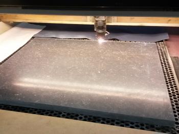 The freestone slab being cut with a laser.